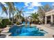 A tranquil pool is surrounded by lounge chairs, palm trees, and well-manicured landscaping for relaxation at 9765 E Lompoc Ave, Mesa, AZ 85209