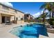 The backyard features a sparkling pool, lush grass, and an outdoor kitchen perfect for entertaining at 9765 E Lompoc Ave, Mesa, AZ 85209