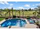 Beautiful pool area with palm trees, lounge chairs, and picturesque golf course views, perfect for relaxation at 9765 E Lompoc Ave, Mesa, AZ 85209