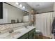 This bathroom features double sinks, a large mirror, and patterned wallpaper at 9853 E Birchwood Ave, Mesa, AZ 85208