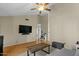 Spacious open-plan living area featuring wood-look floors, high ceilings, and a modern entertainment setup at 9853 E Birchwood Ave, Mesa, AZ 85208