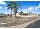 Landscaped front yard with palm trees and decorative accents, adding curb appeal to this lovely home at 1056 S 79Th St, Mesa, AZ 85208