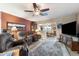 Inviting living room with comfortable seating, large TV, ceiling fan, and stylish area rug at 1056 S 79Th St, Mesa, AZ 85208