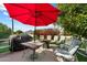 Outdoor patio area with a grill, table, umbrella, and seating at 1056 S 79Th St, Mesa, AZ 85208