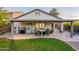 Spacious covered patio with seating, grill, and refrigerator perfect for outdoor entertaining and dining at 10594 E Wallflower Ln, Florence, AZ 85132