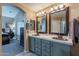 Bathroom features double sinks, modern fixtures, vanity lighting and tile surround in shower/tub at 10594 E Wallflower Ln, Florence, AZ 85132