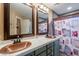 Bathroom features double sinks, modern fixtures, vanity lighting and tile surround in shower/tub at 10594 E Wallflower Ln, Florence, AZ 85132