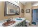 Charming bathroom with a unique copper sink, modern fixtures, and stylish decor at 10594 E Wallflower Ln, Florence, AZ 85132