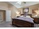 Bedroom featuring carpet, a ceiling fan, large bed, and side tables with lamps at 10594 E Wallflower Ln, Florence, AZ 85132