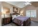 Bedroom featuring carpet, a ceiling fan, large bed, and side tables with lamps at 10594 E Wallflower Ln, Florence, AZ 85132