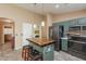 Well-equipped kitchen featuring a central island with seating, modern appliances, and stylish cabinetry at 10594 E Wallflower Ln, Florence, AZ 85132