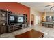 Spacious living room boasts neutral tones, tile flooring, an entertainment center, and seamlessly connects to the kitchen at 10594 E Wallflower Ln, Florence, AZ 85132