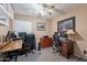 Spacious home office with multiple workstations and custom built-in storage cabinets at 10594 E Wallflower Ln, Florence, AZ 85132