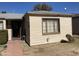 Single-story home featuring a cozy front entrance and classic design with window at 110 E 8Th St, Casa Grande, AZ 85122