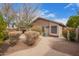 Charming backyard showcasing a low-maintenance desert landscape with gravel pathways and mature vegetation at 1148 S Sierra St, Gilbert, AZ 85296