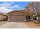 Charming single-story home with a well-maintained front yard, a two-car garage and desert landscaping at 1148 S Sierra St, Gilbert, AZ 85296