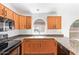 Well-lit kitchen showcasing wood cabinets, granite countertops, stainless steel sink and tile flooring at 1148 S Sierra St, Gilbert, AZ 85296