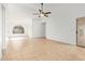 Spacious living room featuring tile flooring, arched window and sliding glass door leading to outdoor space at 1148 S Sierra St, Gilbert, AZ 85296