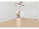 Bright living room with neutral tile floors, featuring a vaulted ceiling, glass slider and front door access at 1148 S Sierra St, Gilbert, AZ 85296