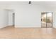 Bright living room with neutral tile floors, featuring a vaulted ceiling, glass slider and hall access at 1148 S Sierra St, Gilbert, AZ 85296