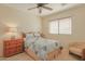 Relaxing bedroom with a large window, ceiling fan, natural lighting, carpeted floors, and matching furniture set at 11500 E Cochise Dr # 2088, Scottsdale, AZ 85259