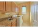 Bright laundry room featuring granite counters, cabinets, and a modern washer and dryer at 11500 E Cochise Dr # 2088, Scottsdale, AZ 85259