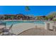 Large community pool area surrounded by lounge chairs, palm trees, and manicured grounds at 11500 E Cochise Dr # 2088, Scottsdale, AZ 85259