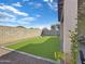 Artificial grass backyard with a play area, swings, and slide surrounded by a block wall for privacy at 12017 N 151St Dr, Surprise, AZ 85379