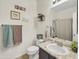 Cozy bathroom featuring a vanity with sink, toilet, and shower with decorative wall art and modern towel rack at 12017 N 151St Dr, Surprise, AZ 85379