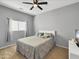 Comfortable bedroom featuring a ceiling fan, neutral walls, and a queen size bed with decorative pillows at 12017 N 151St Dr, Surprise, AZ 85379