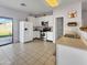 Bright kitchen with ample cabinet space, stainless steel appliances, and tile flooring at 12017 N 151St Dr, Surprise, AZ 85379