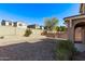 The backyard is landscaped with desert rock and features a block wall for privacy at 12132 W Ashby Dr, Peoria, AZ 85383