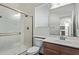 This bathroom boasts a tiled glass shower, framed mirror, and light wood vanity at 12132 W Ashby Dr, Peoria, AZ 85383