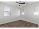 This bedroom includes a ceiling fan, neutral carpet, and three bright windows at 12132 W Ashby Dr, Peoria, AZ 85383