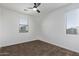 This bedroom has neutral carpet, and two large bright windows with blinds at 12132 W Ashby Dr, Peoria, AZ 85383