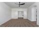 A primary bedroom features neutral walls, carpeted floors and a ceiling fan at 12132 W Ashby Dr, Peoria, AZ 85383