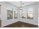 Bright breakfast nook bathed in natural light, complemented by a stylish light fixture and wood flooring at 12132 W Ashby Dr, Peoria, AZ 85383