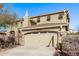 Two-story home with a two-car garage, stone accents, and a tiled roof at 12132 W Ashby Dr, Peoria, AZ 85383