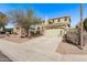 Two-story home featuring a two-car garage, desert landscaping, and sidewalks at 12132 W Ashby Dr, Peoria, AZ 85383