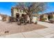 Two-story home featuring a two-car garage, desert landscaping, and sidewalk at 12132 W Ashby Dr, Peoria, AZ 85383