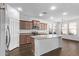 Well-lit kitchen with stainless steel appliances, granite countertops, and an island with a sink at 12132 W Ashby Dr, Peoria, AZ 85383