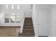 Carpeted staircase leading to the second floor with ample natural light from nearby windows at 12132 W Ashby Dr, Peoria, AZ 85383