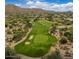 Expansive aerial shot of a lush golf course nestled in a desert landscape at 12946 N 116 St # 24, Scottsdale, AZ 85259