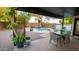 Inviting backyard with pool, outdoor dining area, mature plants, and gravel landscaping at 13451 S 47Th Way, Phoenix, AZ 85044