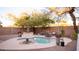 Inviting backyard pool with surrounding patio, landscaping, lounge seating, and ambient string lights for relaxing outdoor living at 13451 S 47Th Way, Phoenix, AZ 85044