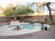 Inviting backyard pool with surrounding patio, landscaping, lounge seating, and ambient string lights for relaxing outdoor living at 13451 S 47Th Way, Phoenix, AZ 85044