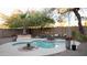 Inviting backyard pool with surrounding patio, landscaping, lounge seating, and ambient string lights for relaxing outdoor living at 13451 S 47Th Way, Phoenix, AZ 85044