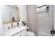 Well-lit bathroom with a gold-framed mirror, neutral shower curtain, and modern fixtures at 13451 S 47Th Way, Phoenix, AZ 85044