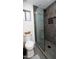 Modern bathroom featuring dark tile, a glass shower, and a sleek toilet at 13451 S 47Th Way, Phoenix, AZ 85044