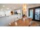 Open floor plan with dining area, featuring a wooden table with seating, adjacent to the kitchen at 13451 S 47Th Way, Phoenix, AZ 85044